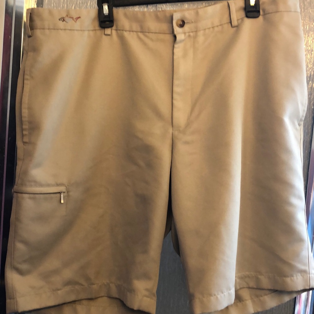 Greg Norman golf shirts, size 40 in a khaki to tan color. 2 side pockets